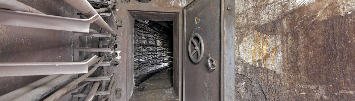 An open protective door in an underground communication tunnel