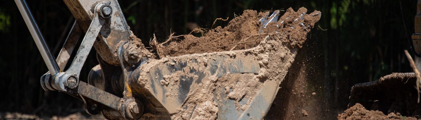 bulldozer machine digging the ground and removing sand for excavation purpose