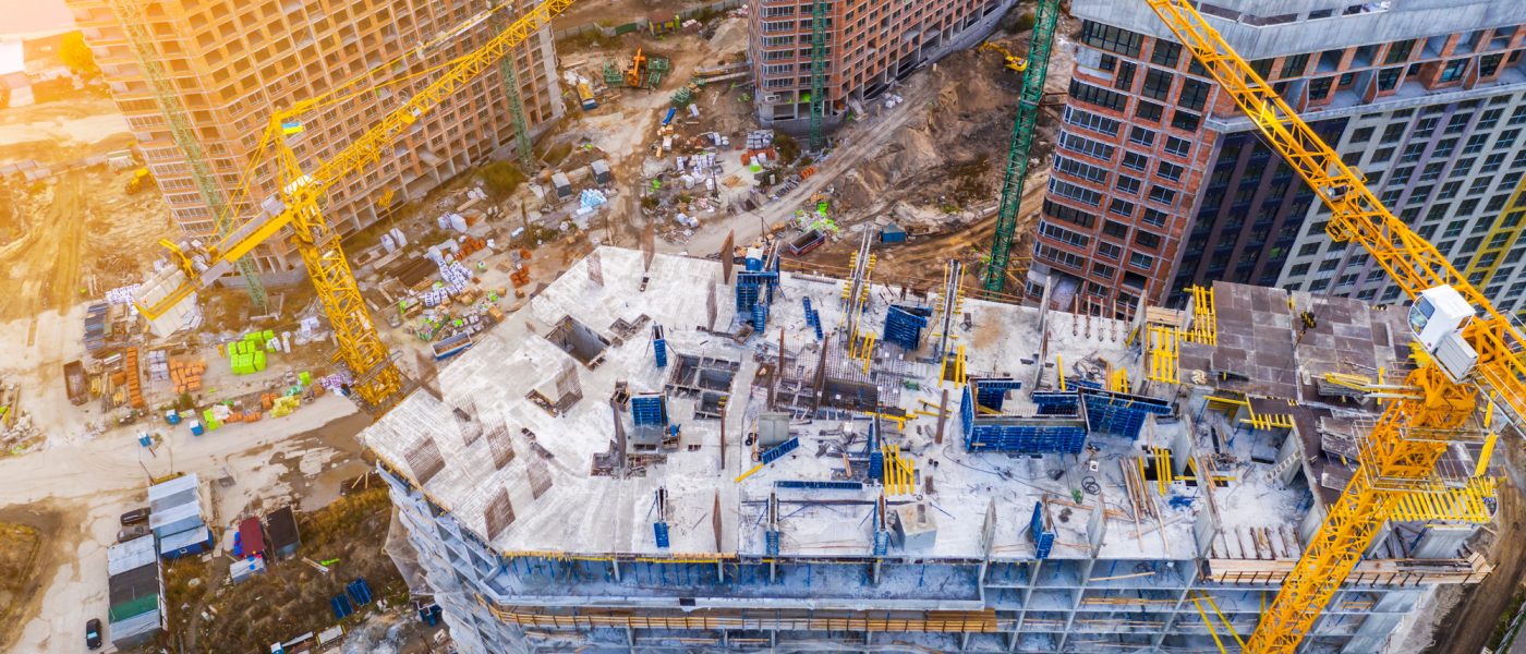 Construction site with cranes at sunset. Construction of an apartment building