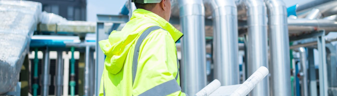 Engineer reads asbuil drawings to inspect chiller water pipes