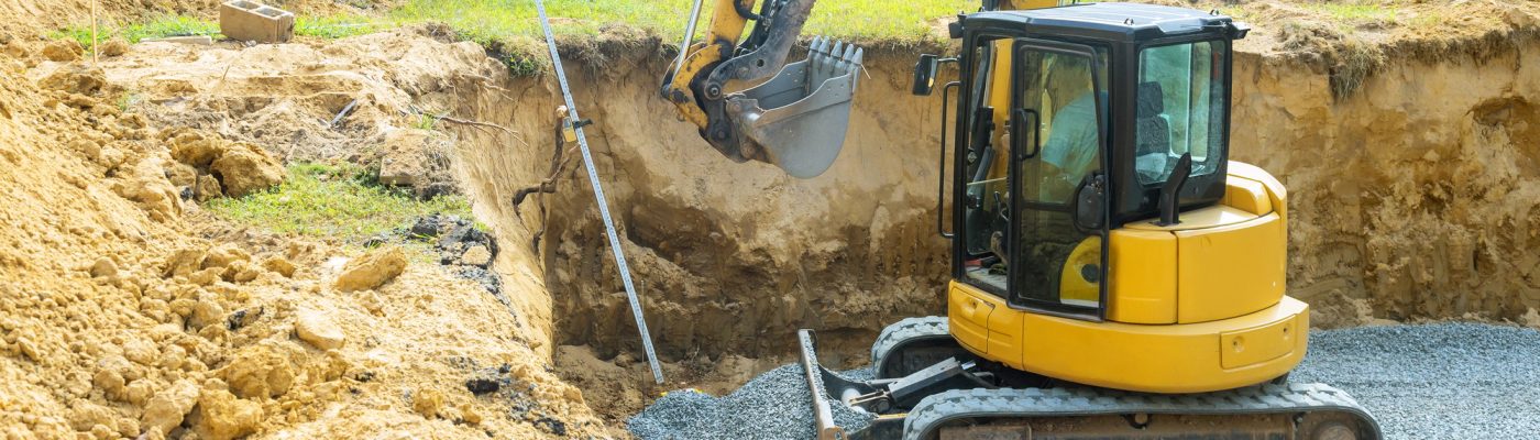 Excavators fill irregularities in excavations with granite rubble bases, which are used to form