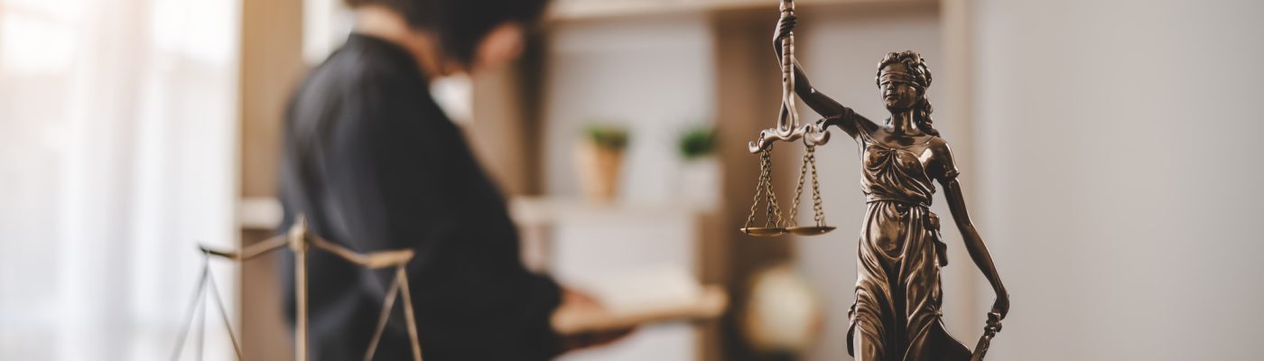 Lady Justice Holding Scales of Law in a Courtroom - Symbolizing Equality, Fairness