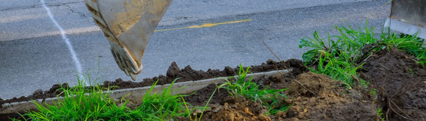 Paving out sewer line machinery for road work, excavating, loading working at construction