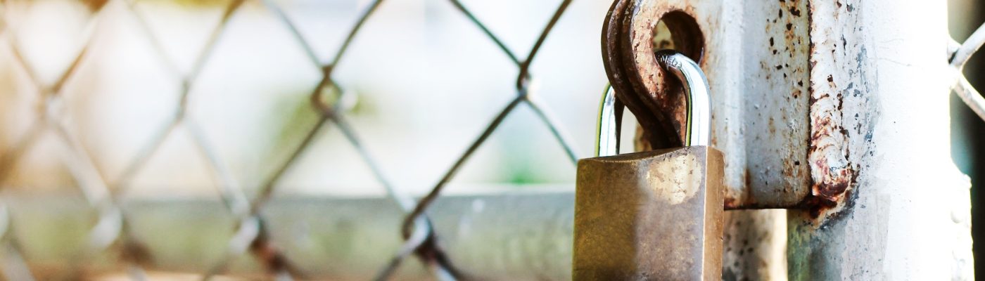 Rusty iron gate locked with at the garden.